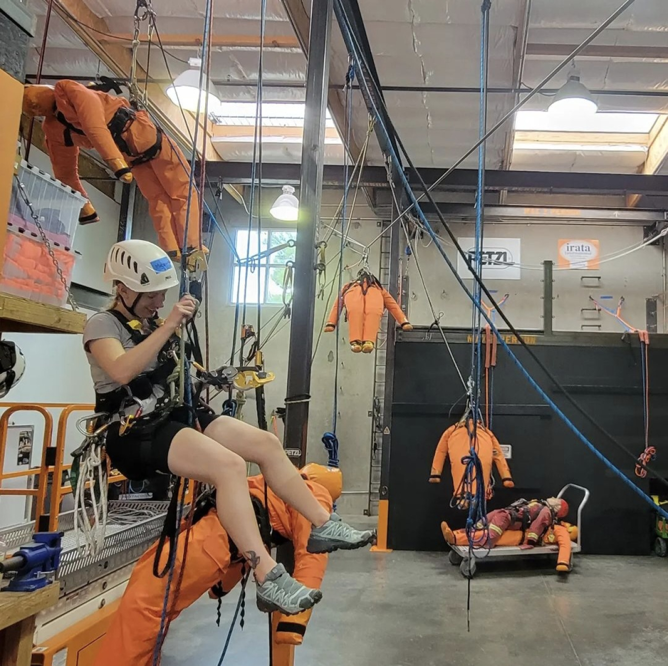 Madeline hanging from the ceiling in a warehouse