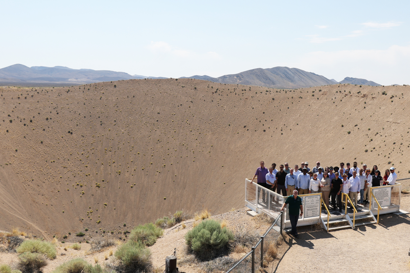 Participants in the transparency visit stand on edge of the Sedan Crater at the Nevada National Security Site.