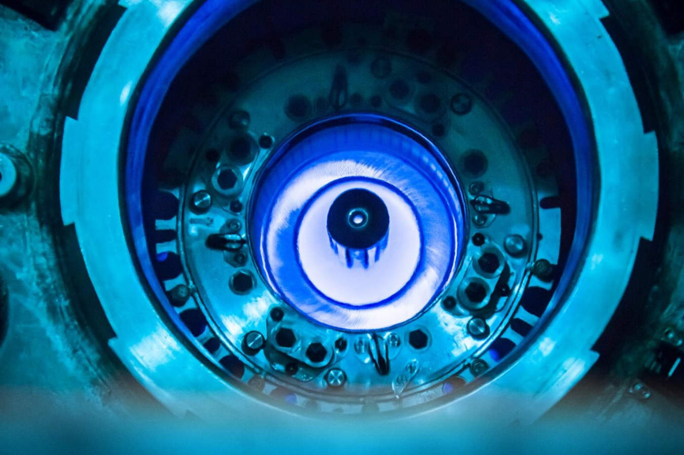 The blue glow at the center of a research reactor at Oak Ridge National Laboratory. The glow is created by electrons emitted in radioactive decays in the radioactive core.