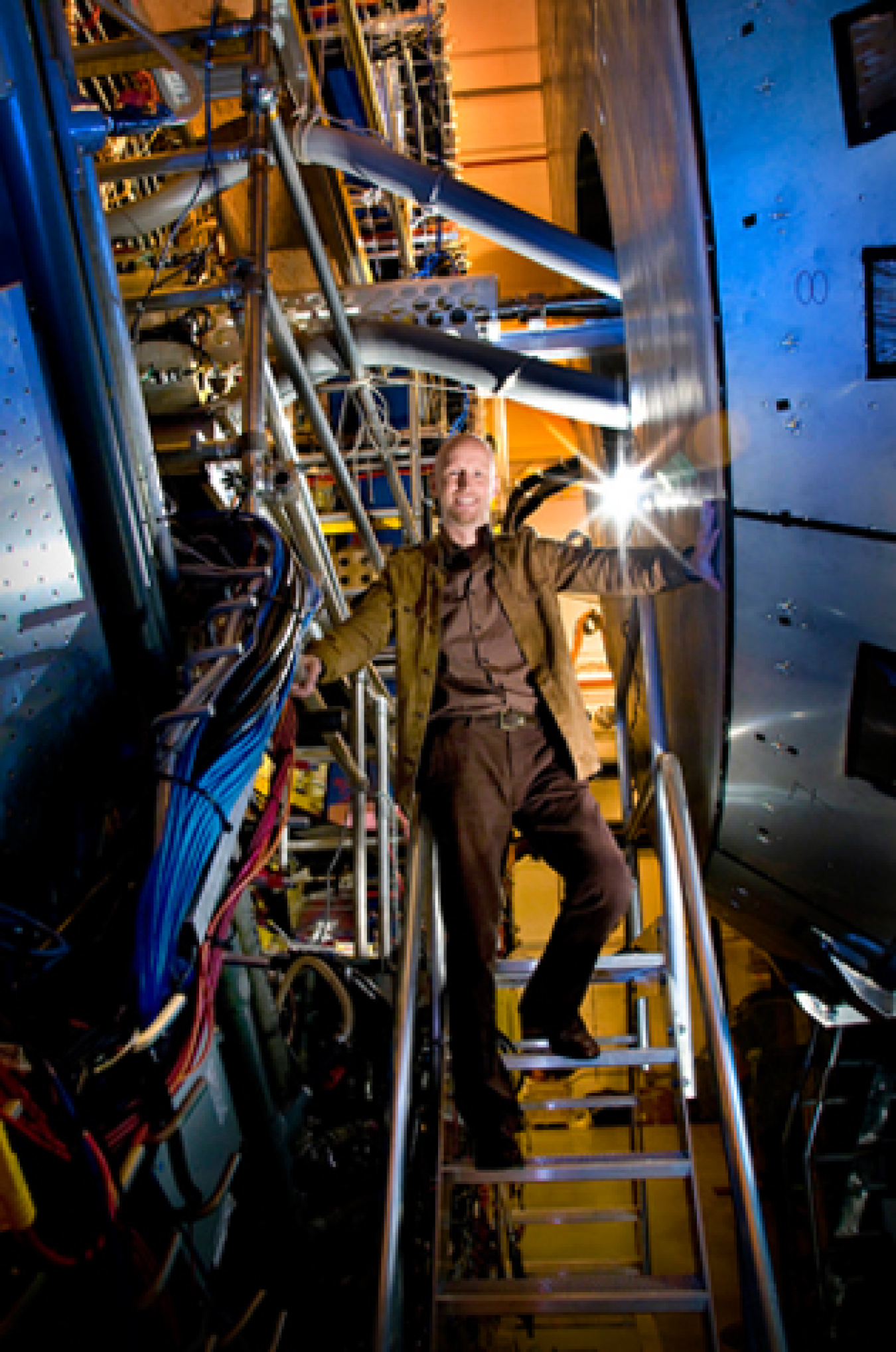 Brookhaven Lab physicist, Paul Sorensen, stands in front of the massive STAR detector at the Relativistic Heavy Ion Collider.