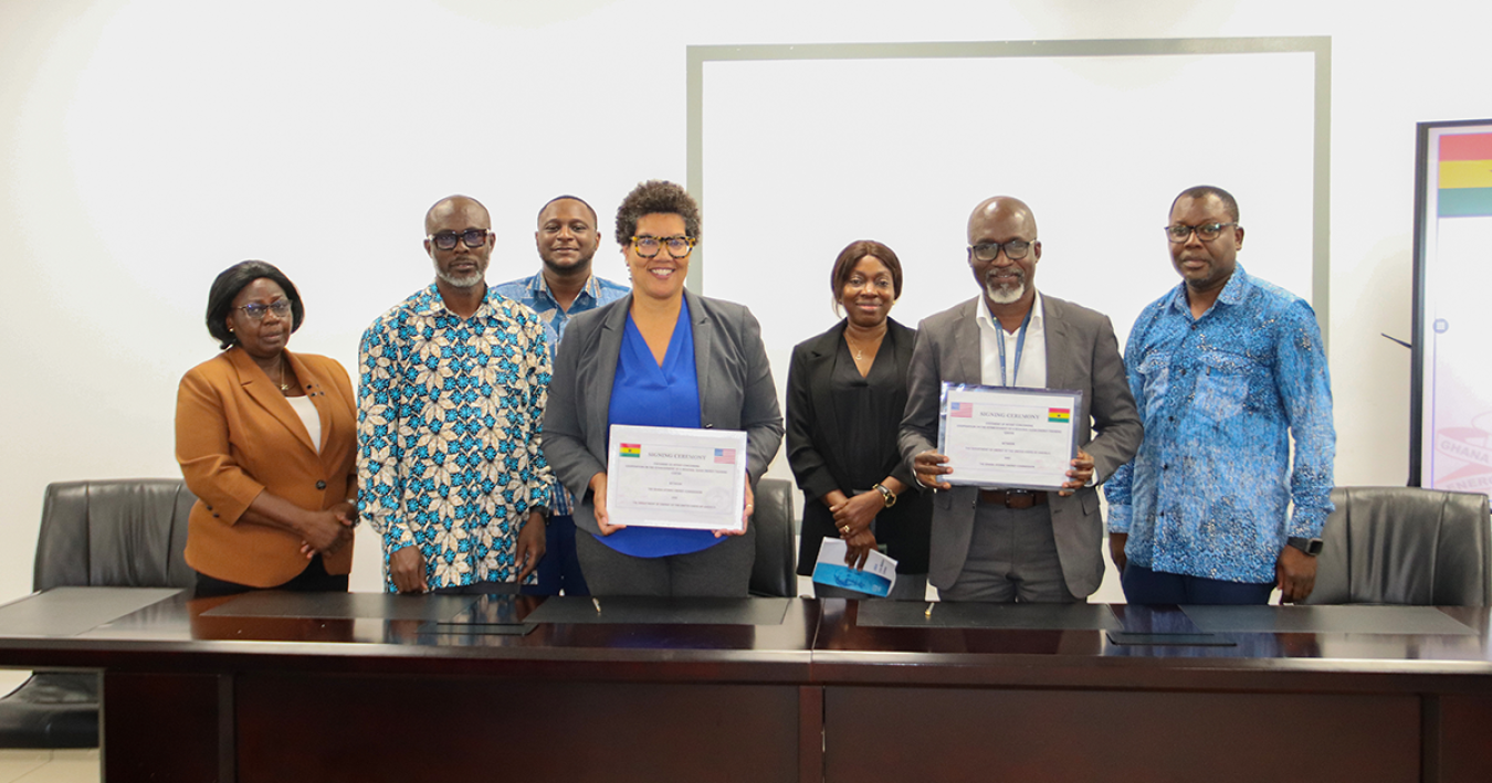 Group of people holding a signed document