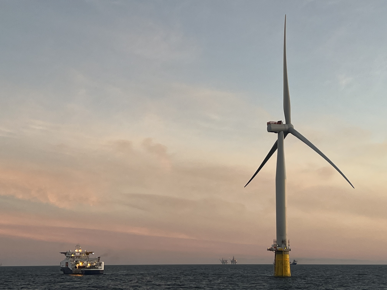 Wind turbine surrounded by water. 