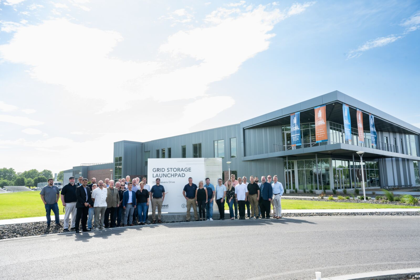 Group of OE and PNNL leaders in front of the new Grid Storage Launchpad sign at PNNL for the dedication ceremony.