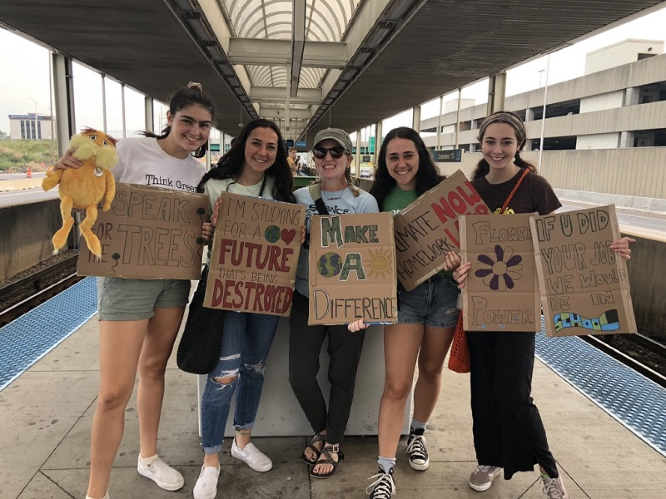 Jessica standing with a group of fellow students on a train platform.