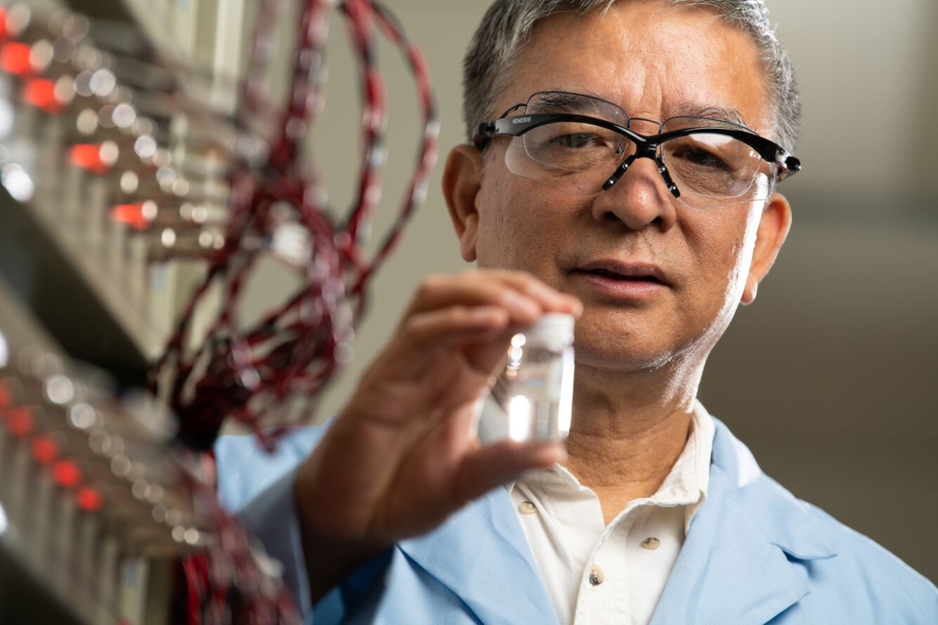 Dr. Jason Zhang holding a vial at PNNL