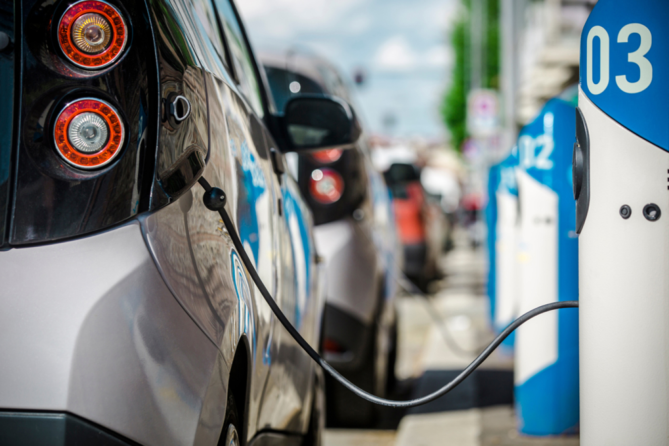 Electric vehicle charged at a charging station.