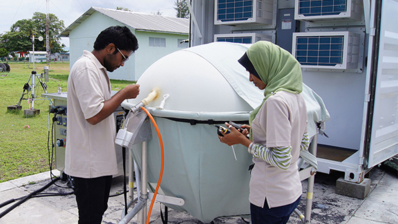 Local observers on Gan Island prepare an instrument for launch as part of the AIME campaign in the winter of 2011.