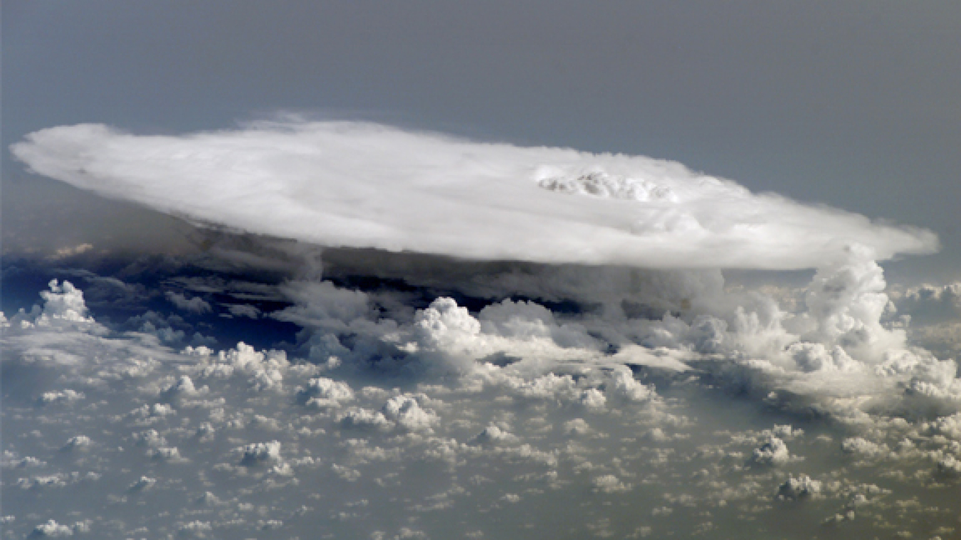 Herds of anvil-shaped clouds form in the tropics as part of the Madden-Julian Oscillation, a pattern of shifting winds and rain that starts over the Indian Ocean and travels eastward every 30 to 90 days. This image, taken from the International Space Station over western Africa, shows the complex nature of these systems.