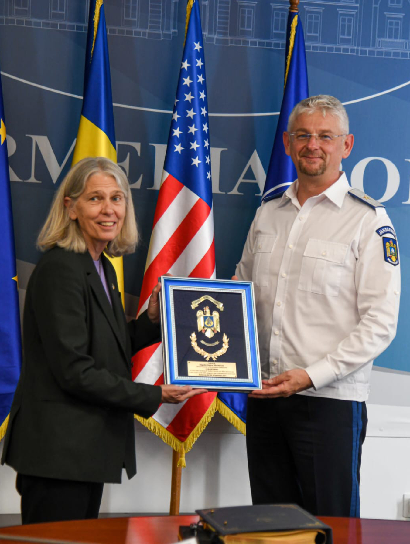 NNSA Administrator Hruby and Alin-Ionel Mastan hold a plaque.