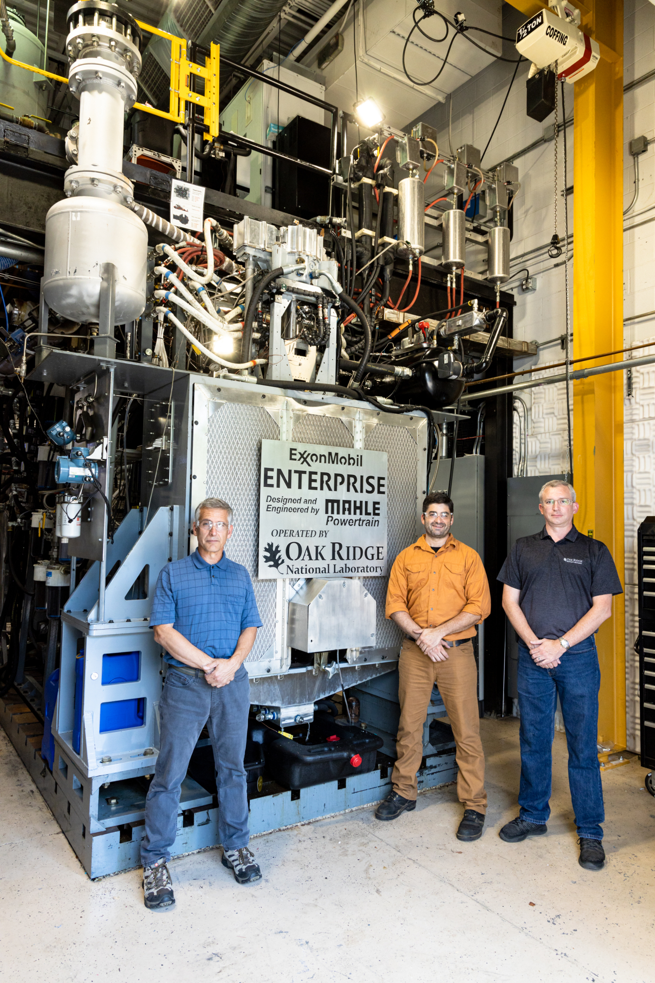 ORNL researchers Mike Kass (left) and Brian Kaul (right) led the study to test biointermediates derived from wood and food waste in the Enterprise. The two are pictured with Eric Nafziger (center), who helped install the engine.