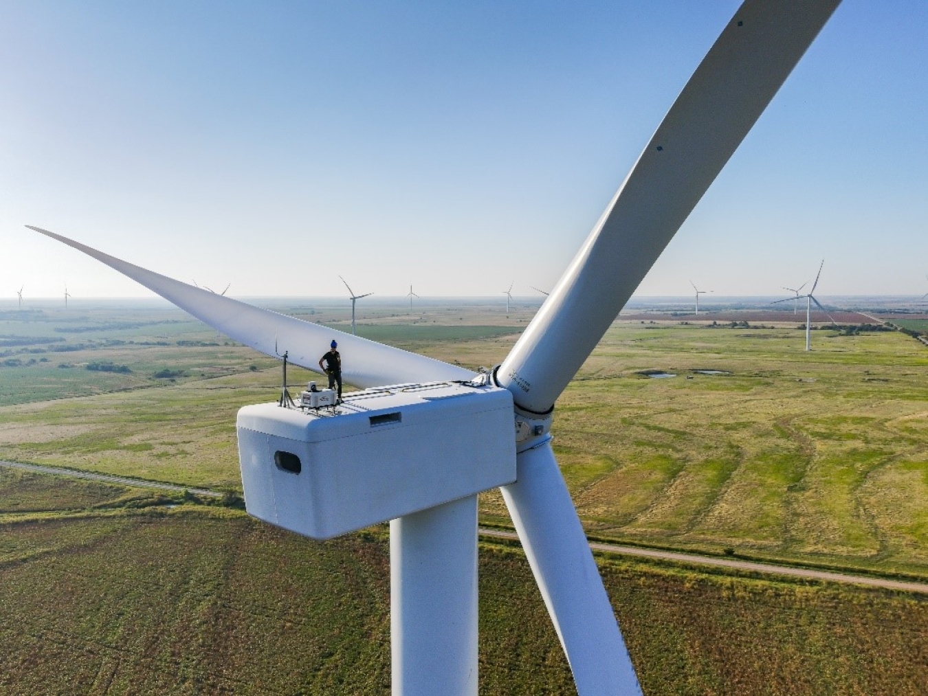 A researcher on top of a wind turbine