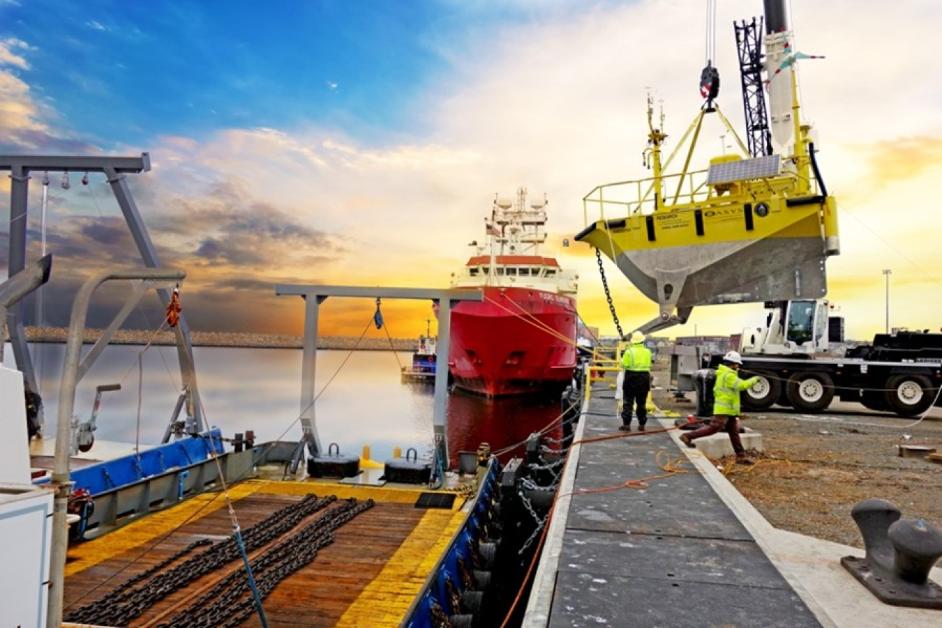 Buoys are being deployed and loaded from a dock to deep waters