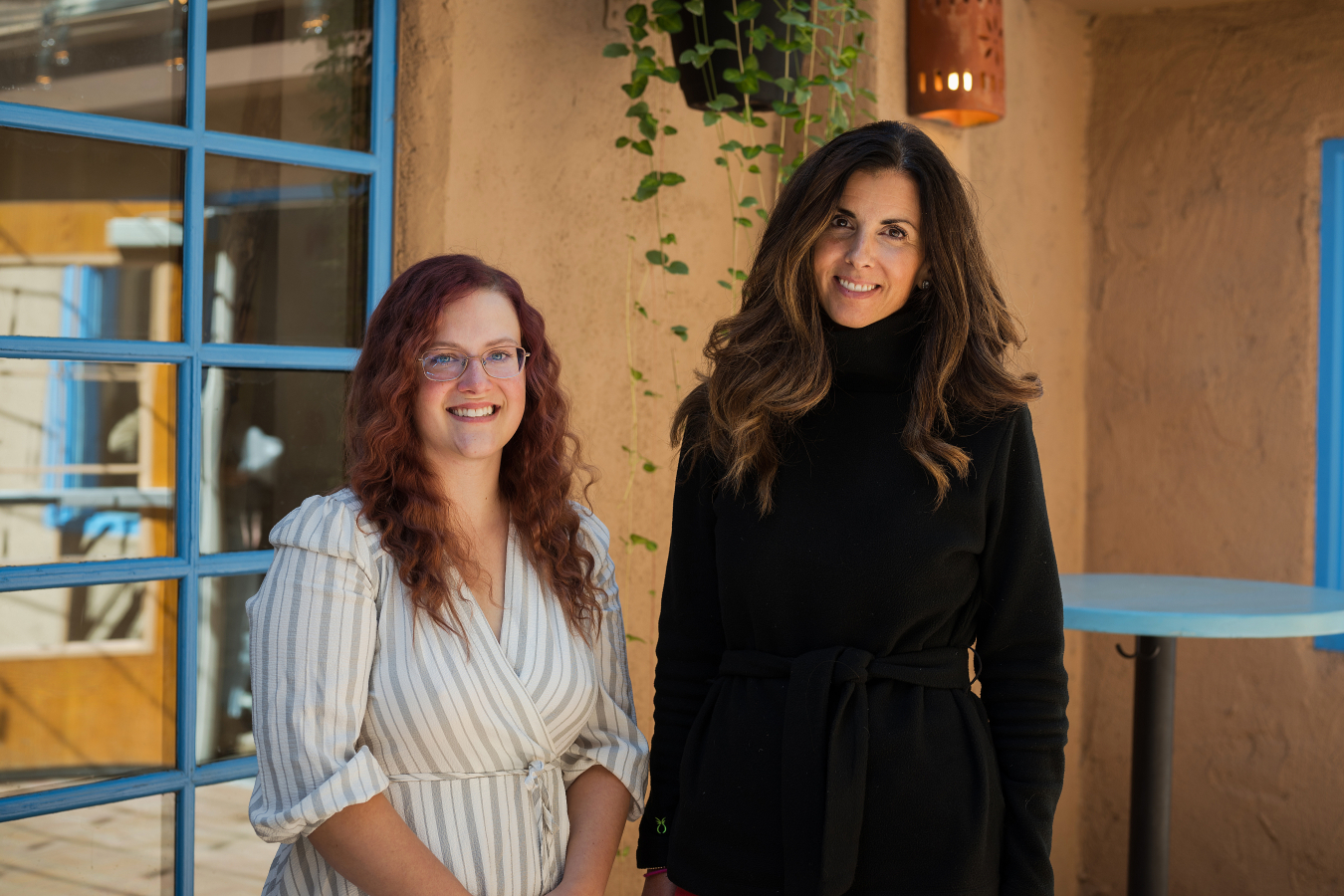 Two people pose and smile for the camera.