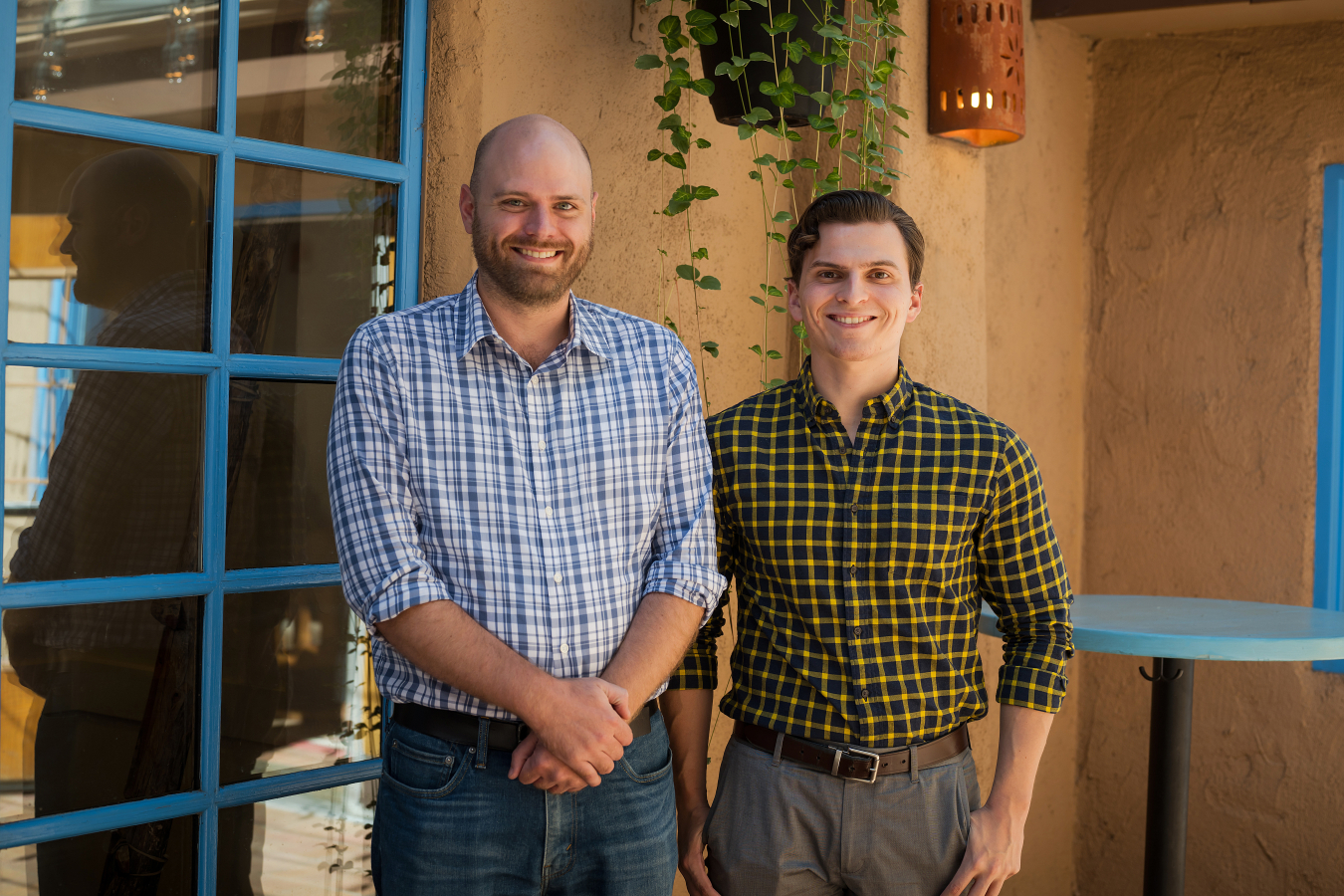 Two people pose and smile for the camera.