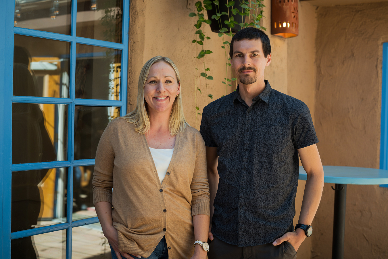 Two people pose and smile for the camera.