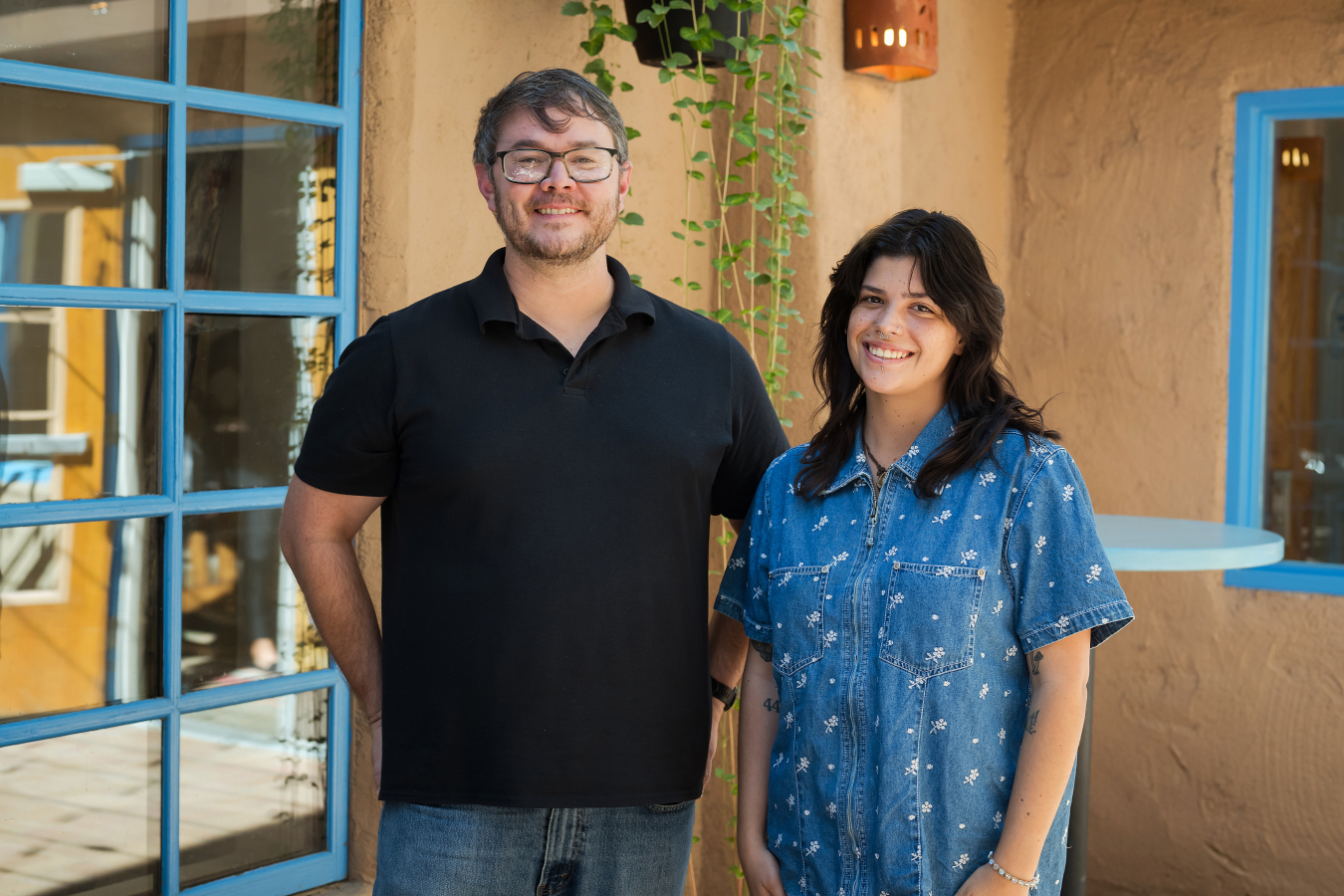 Two people pose and smile for the camera.