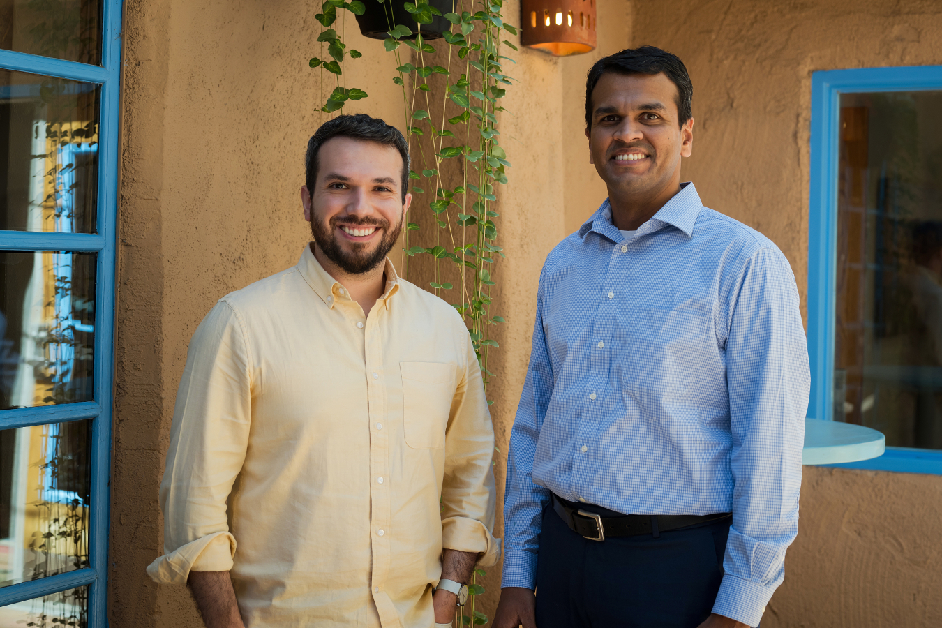 Two people pose and smile for the camera.