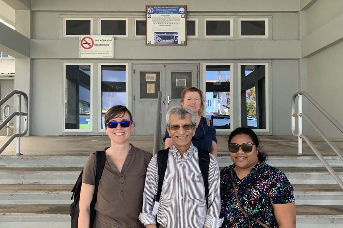 Dr. Ashok Vaswani (middle front) with Nurse Vanissa Toka, Dr. S. Robin Elgart, and Michelle Yamaguchi outside Ebeye Hospital 