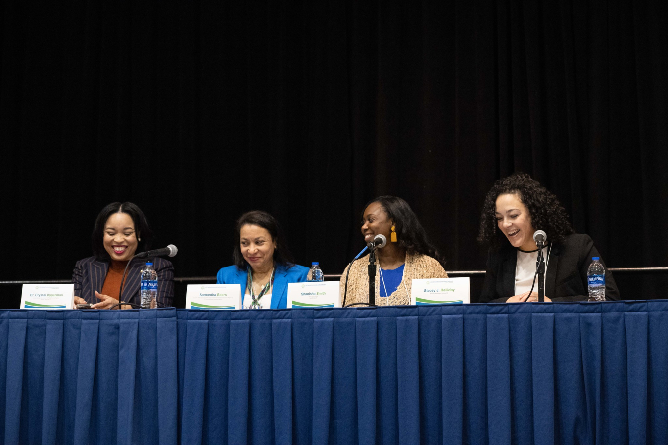 Four women speaking on a panel