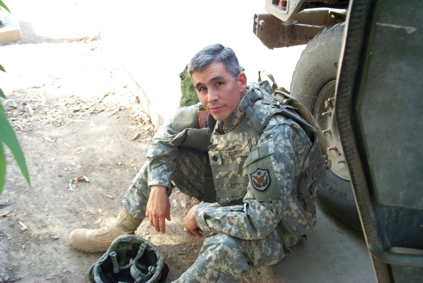 A military person in uniform sitting down.