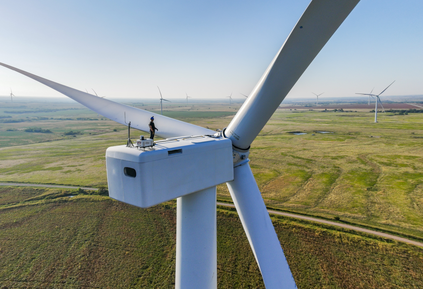 Worker on top of wind turbine