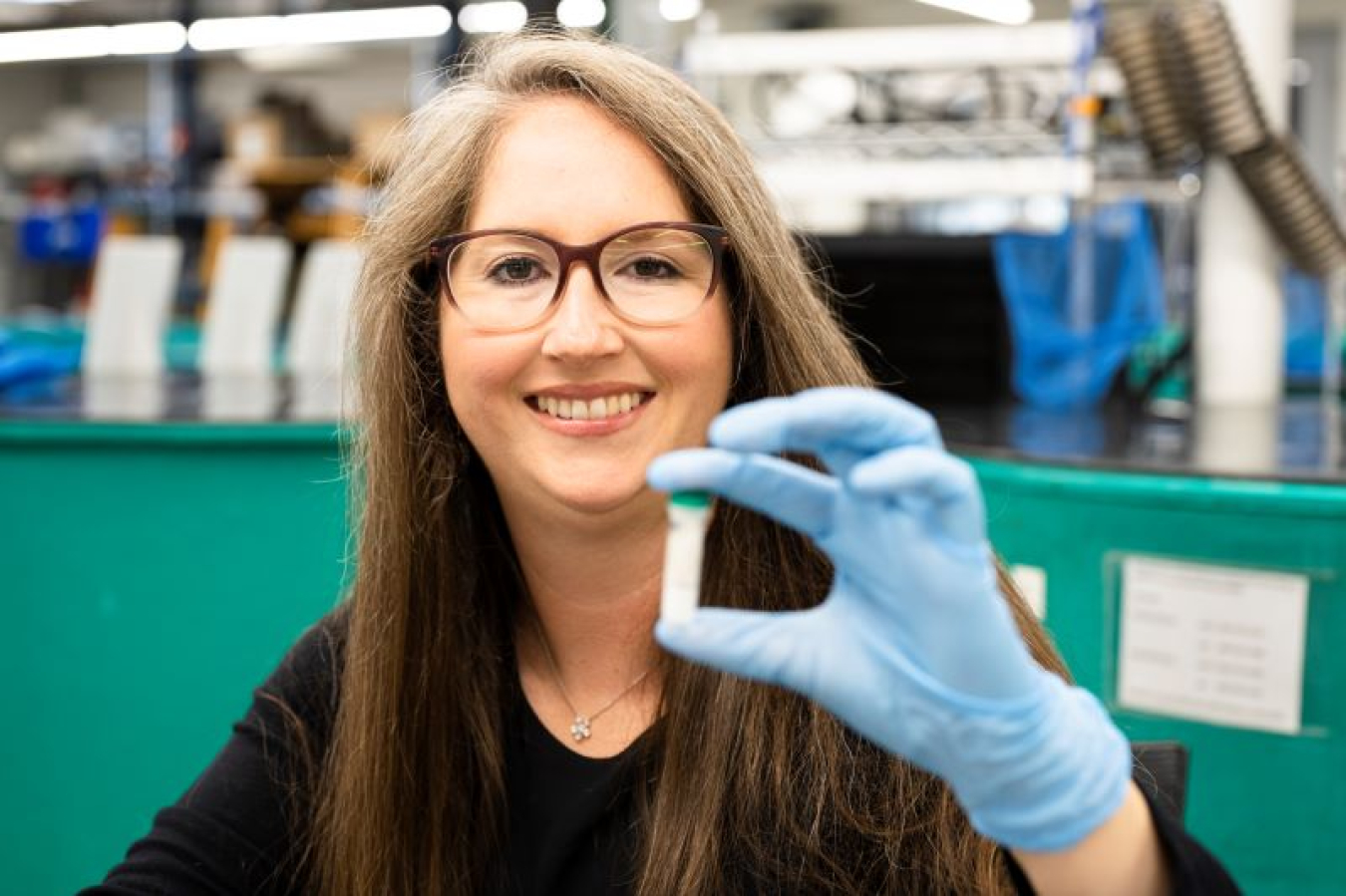 Kristine Moody holding up a small test tube