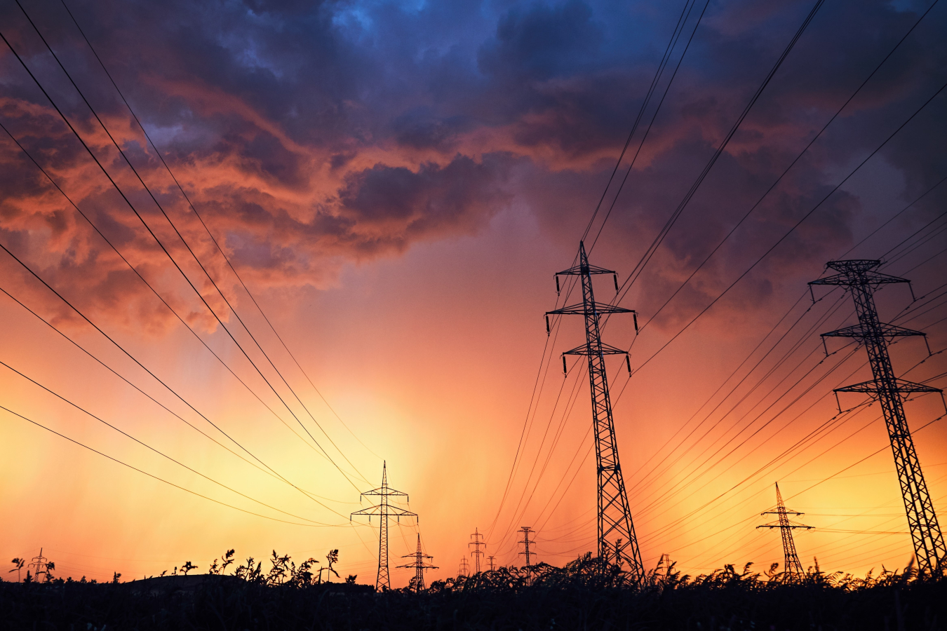 power lines in the midst of a sunset