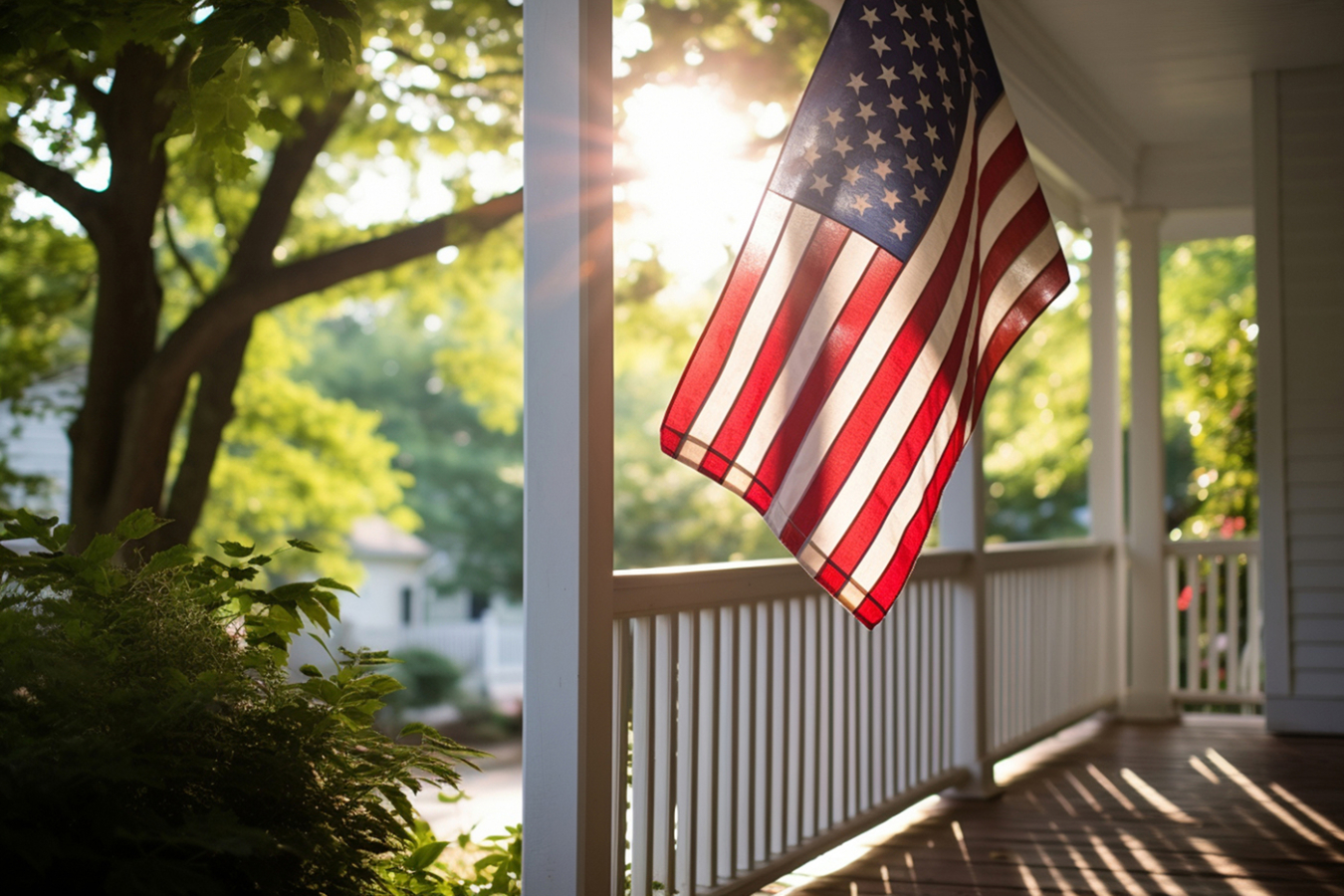 A porch with the American flag hanging on it.