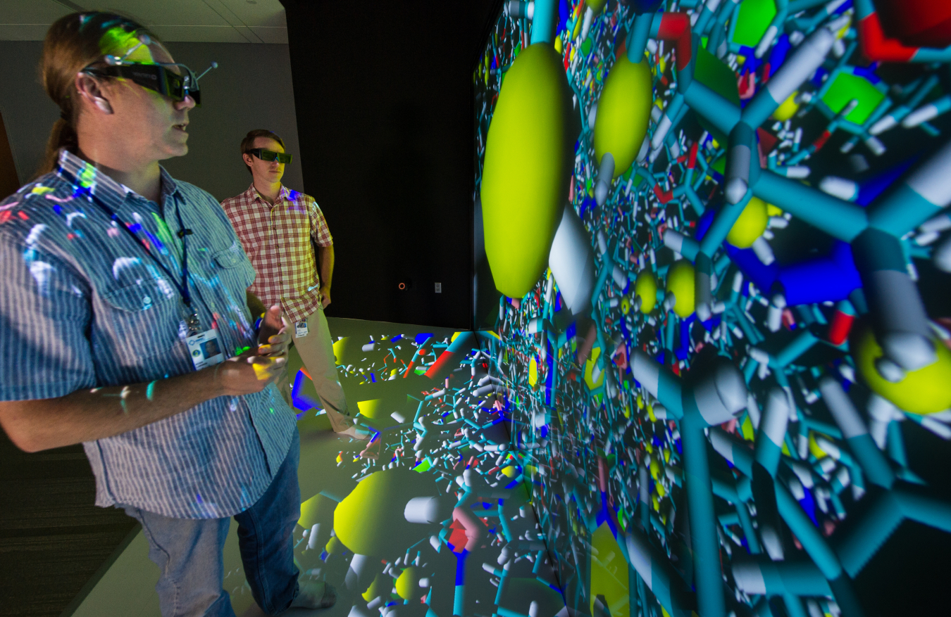 National Renewable Energy Laboratory Senior Scientists Ross Larsen (left) and Travis Kemper examine a molecular model at the Energy Systems Integration Facility.