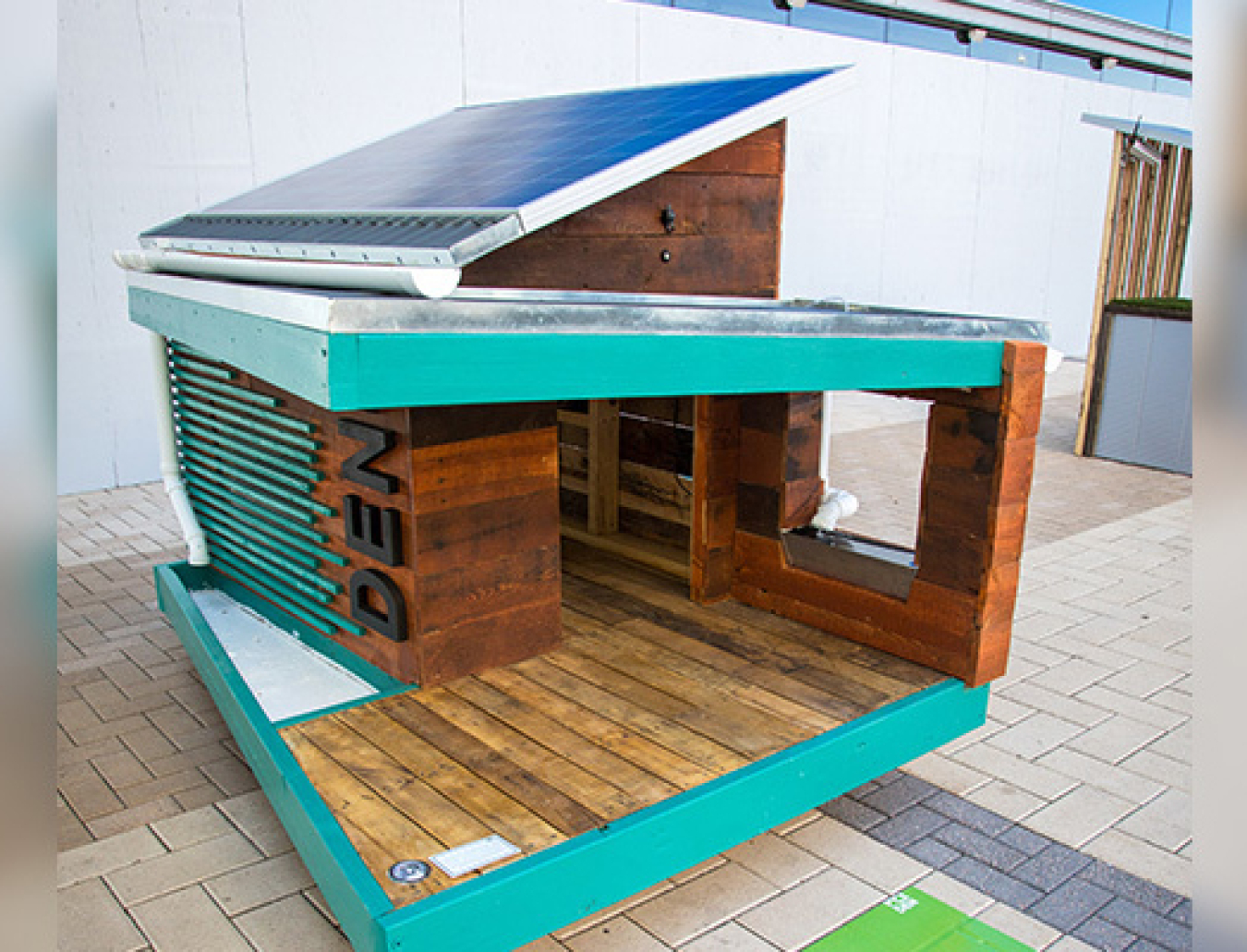 A solar powered dog house on display.