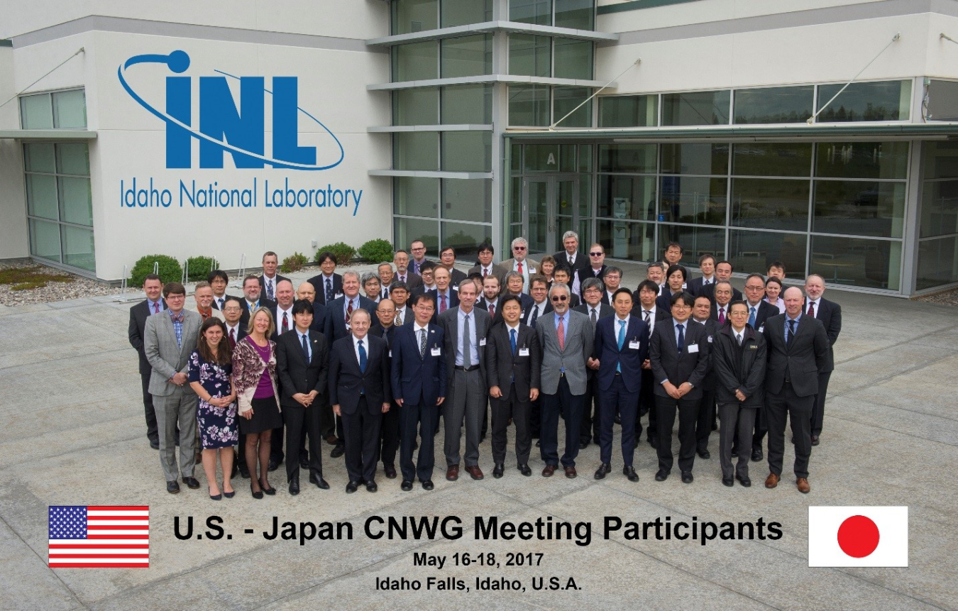 The meeting participants from May 2017 standing facing the camera in front of the Idaho National Lab building entrance.