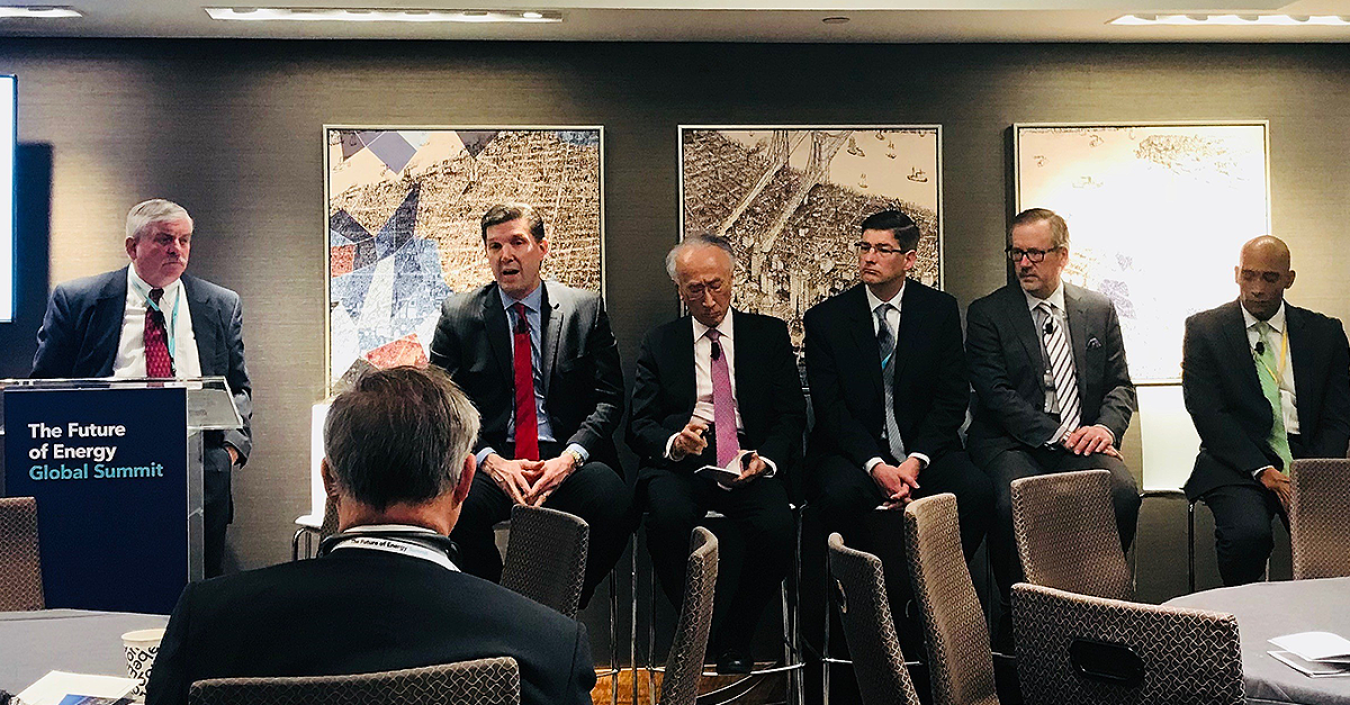 Men talk during a panel about energy and nuclear power.