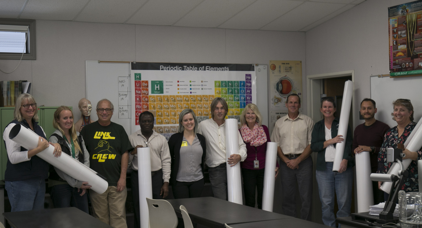 Teachers in Livermore with the donated periodic table posters from Sandia National Laboratories.