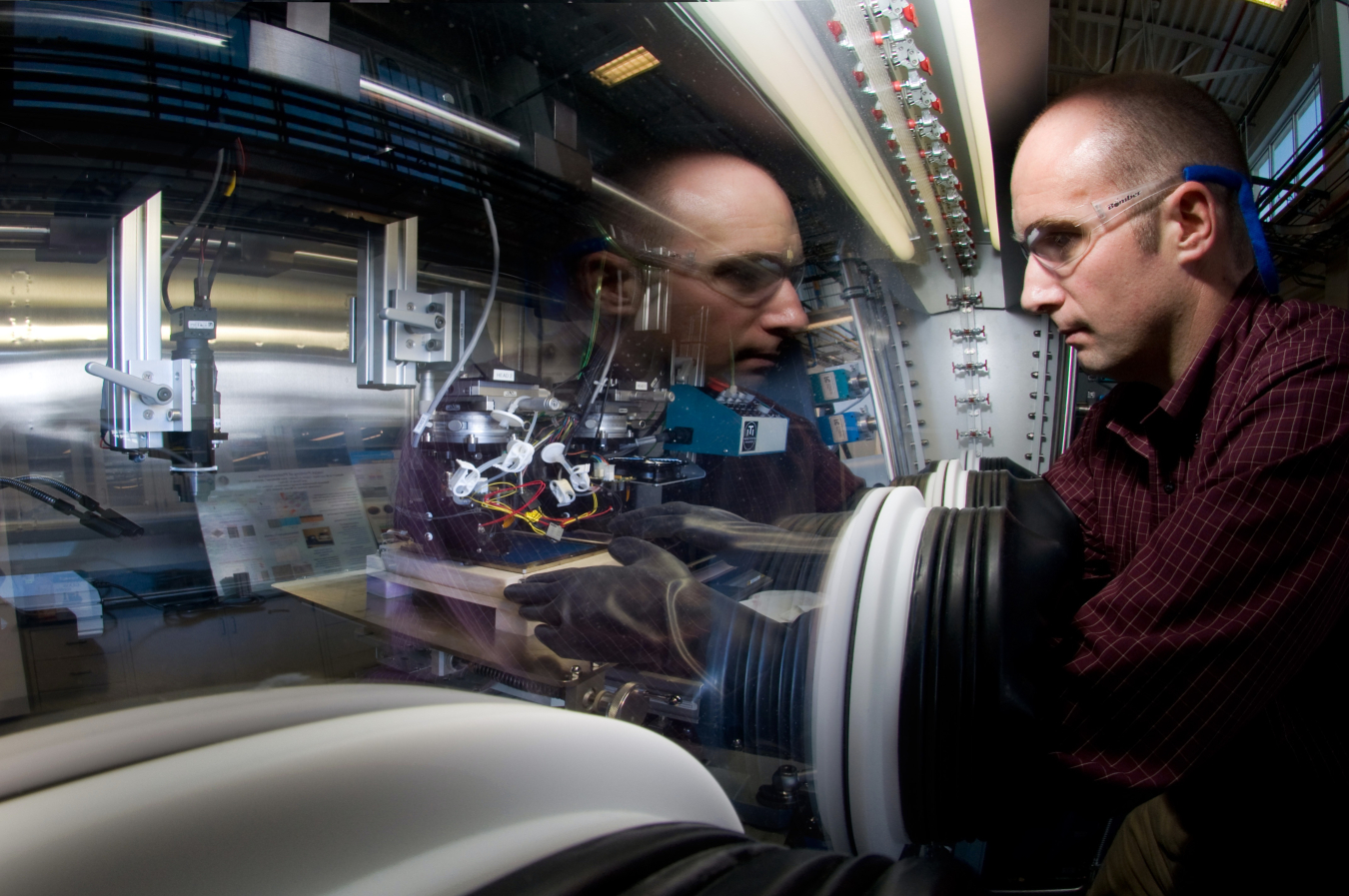 Photo of NREL senior scientist, Robert Tenent, Ph.D., with equipment for low cost processing (deposition) of window coatings materials.