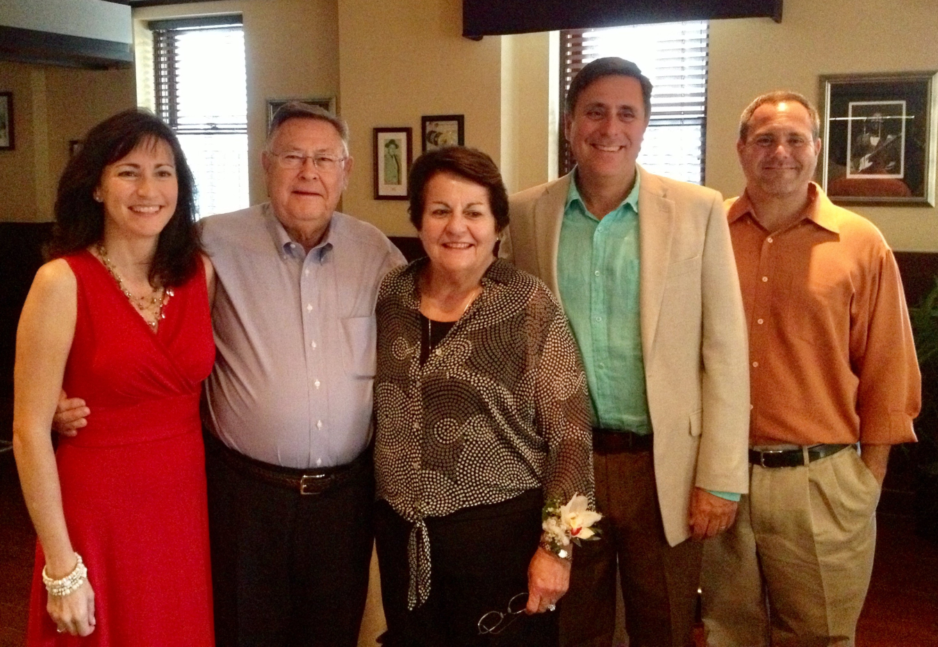 A group family photo of a father and son with their wives.