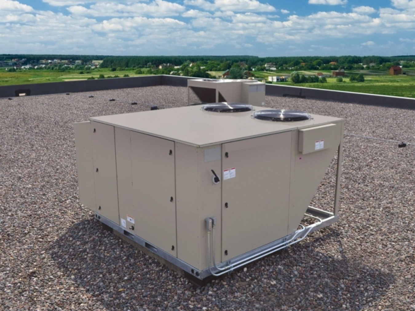 Photo of a rooftop unit on a large commercial of residential building roof.