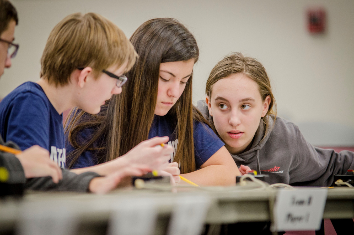 Pictured left to right: Calloway County Middle School students Isaac Martin, Drake Calhoon and Emma Arnett work together to answer questions during the final match of the DOE Regional Science Bowl.