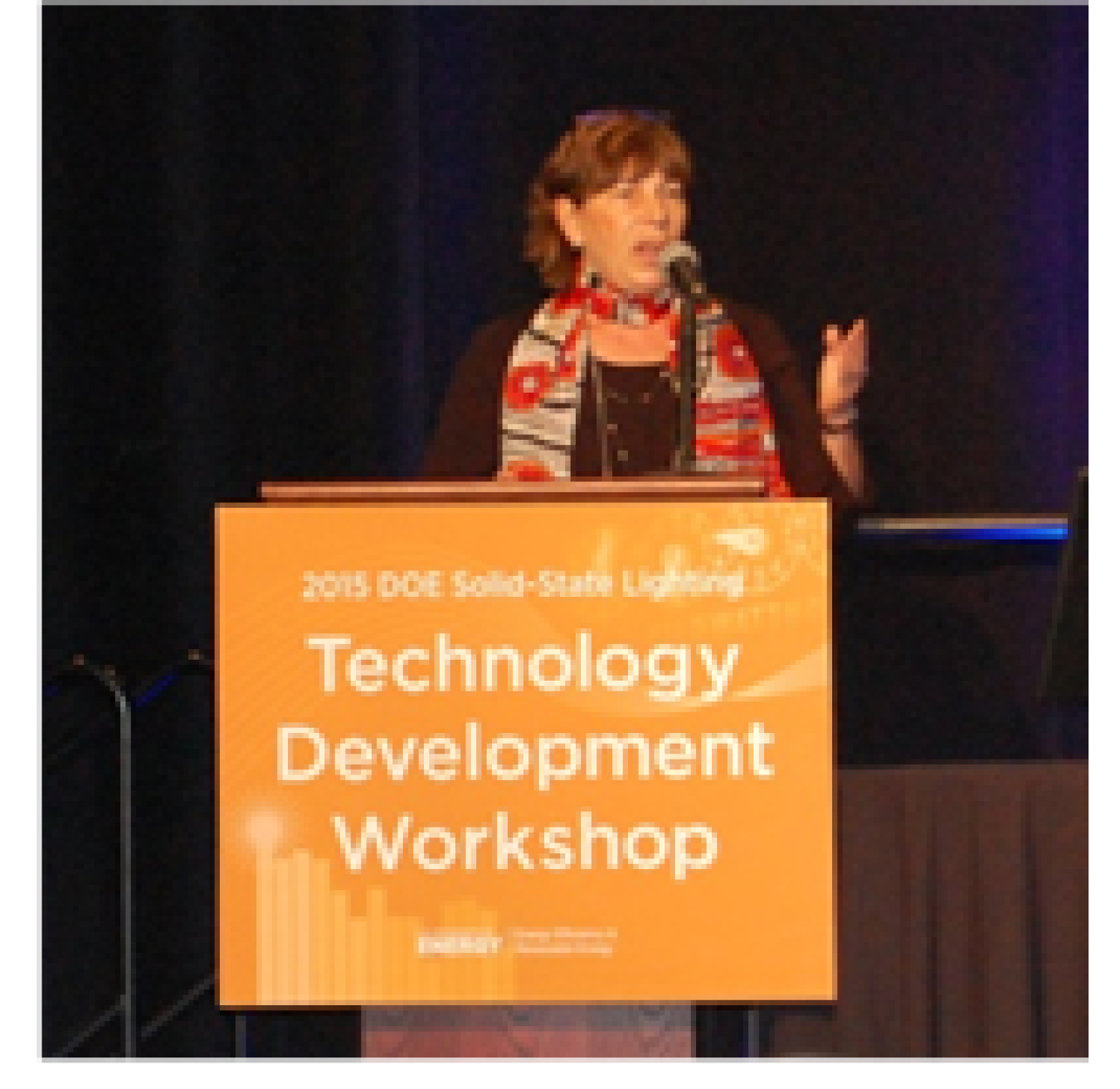 Woman speaking at a lectern.