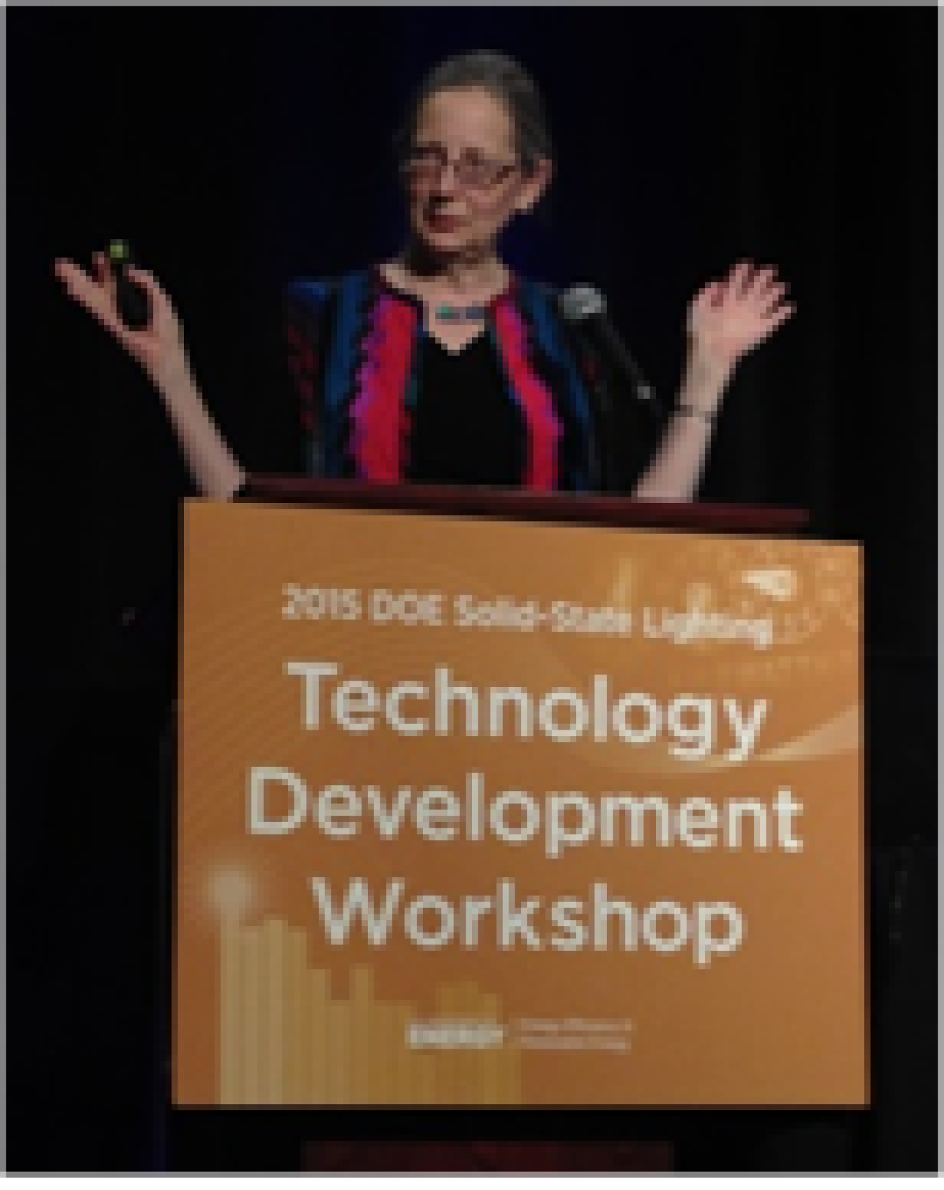 Woman speaking at a lectern.