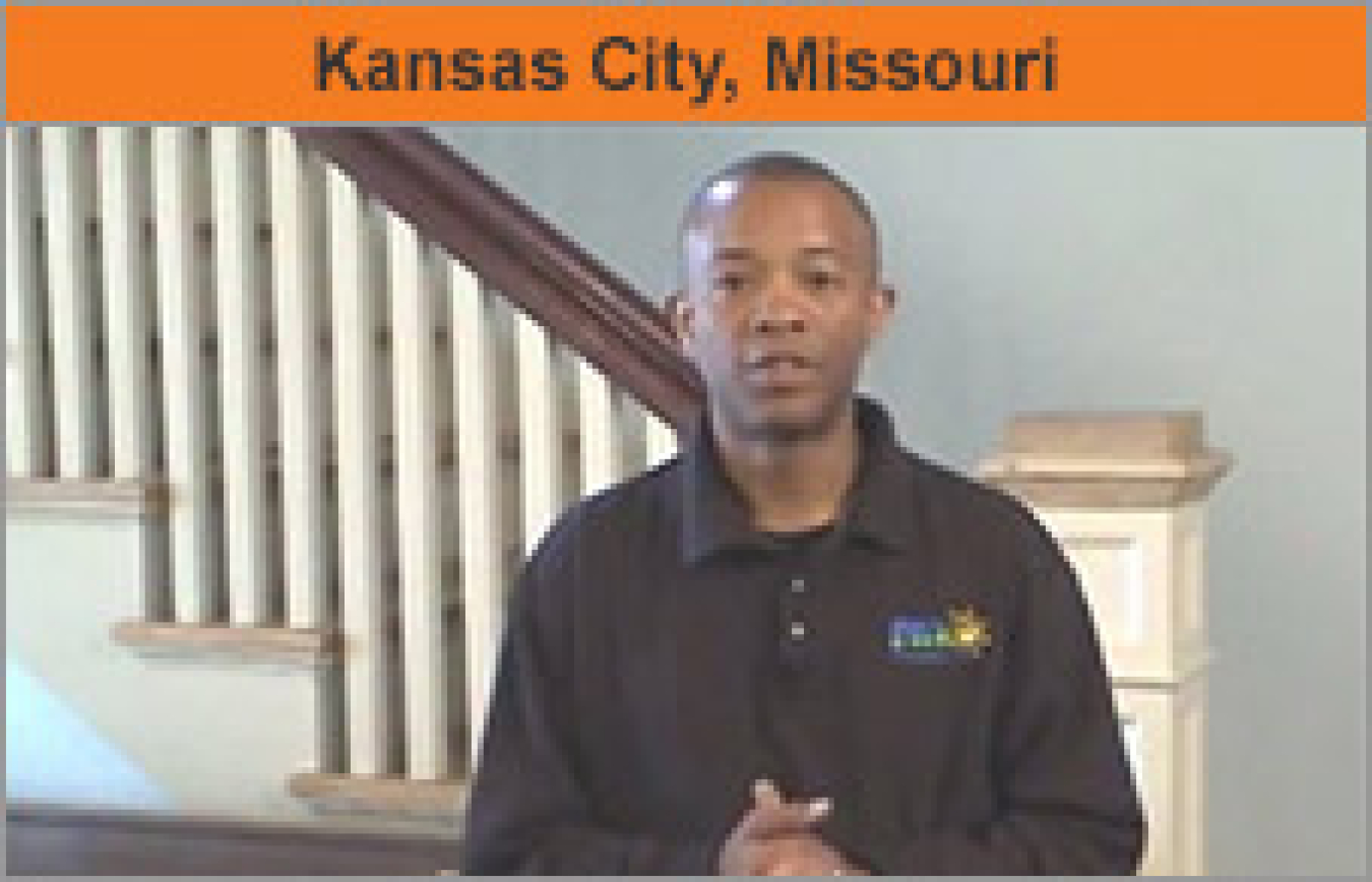 A man standing at a residential staircase, with the words "Kansas City, Missouri."