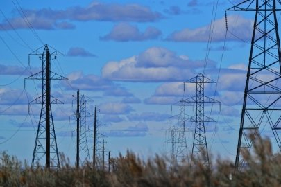 Transmission towers and lines in a field.